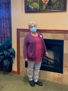 LSM nurse Nicki Foxx poses in the front office in front of a fireplace